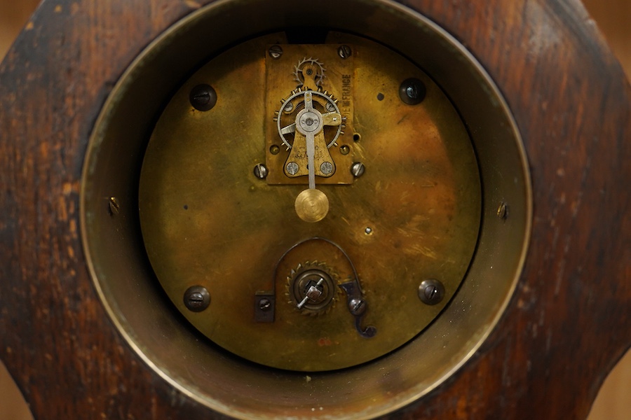 An Art Nouveau copper inlaid oak timepiece, 27cm high. Condition - various elements of copper inlay missing or detached